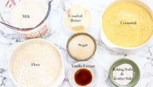 Ingredients on white marble background with words on top of each ingredient