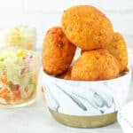 Plantain balls stacked up on top of each other in gray and white bowl