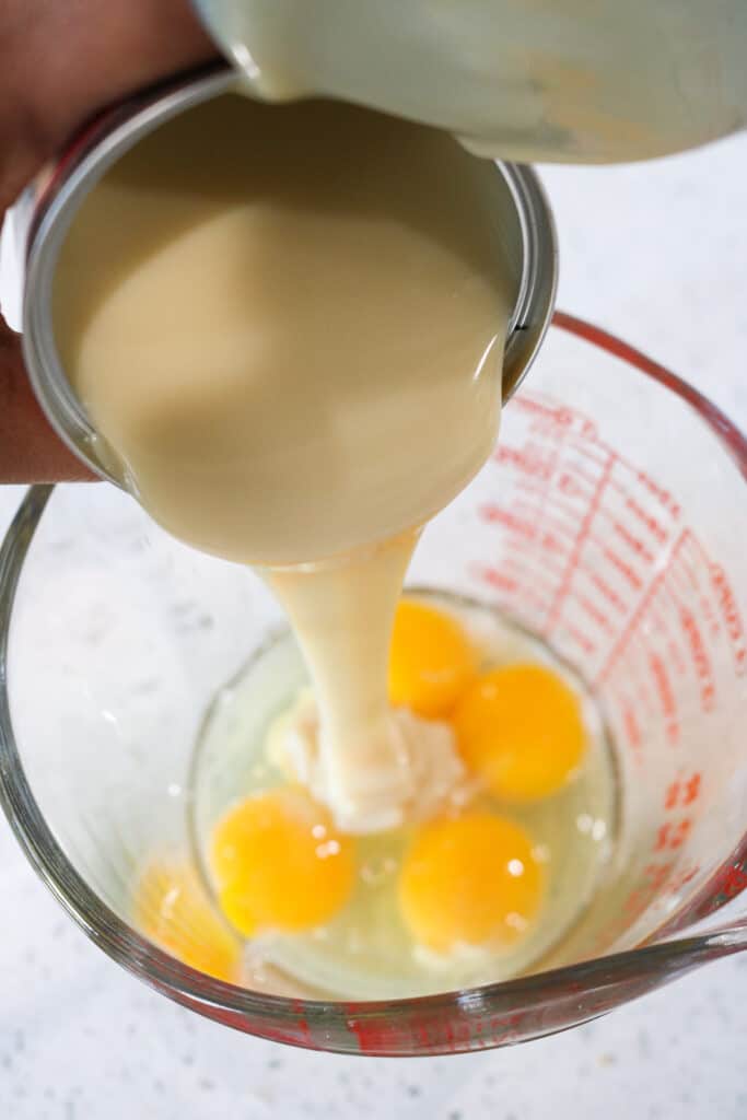 Condensed Milk being poured in glass with eggs