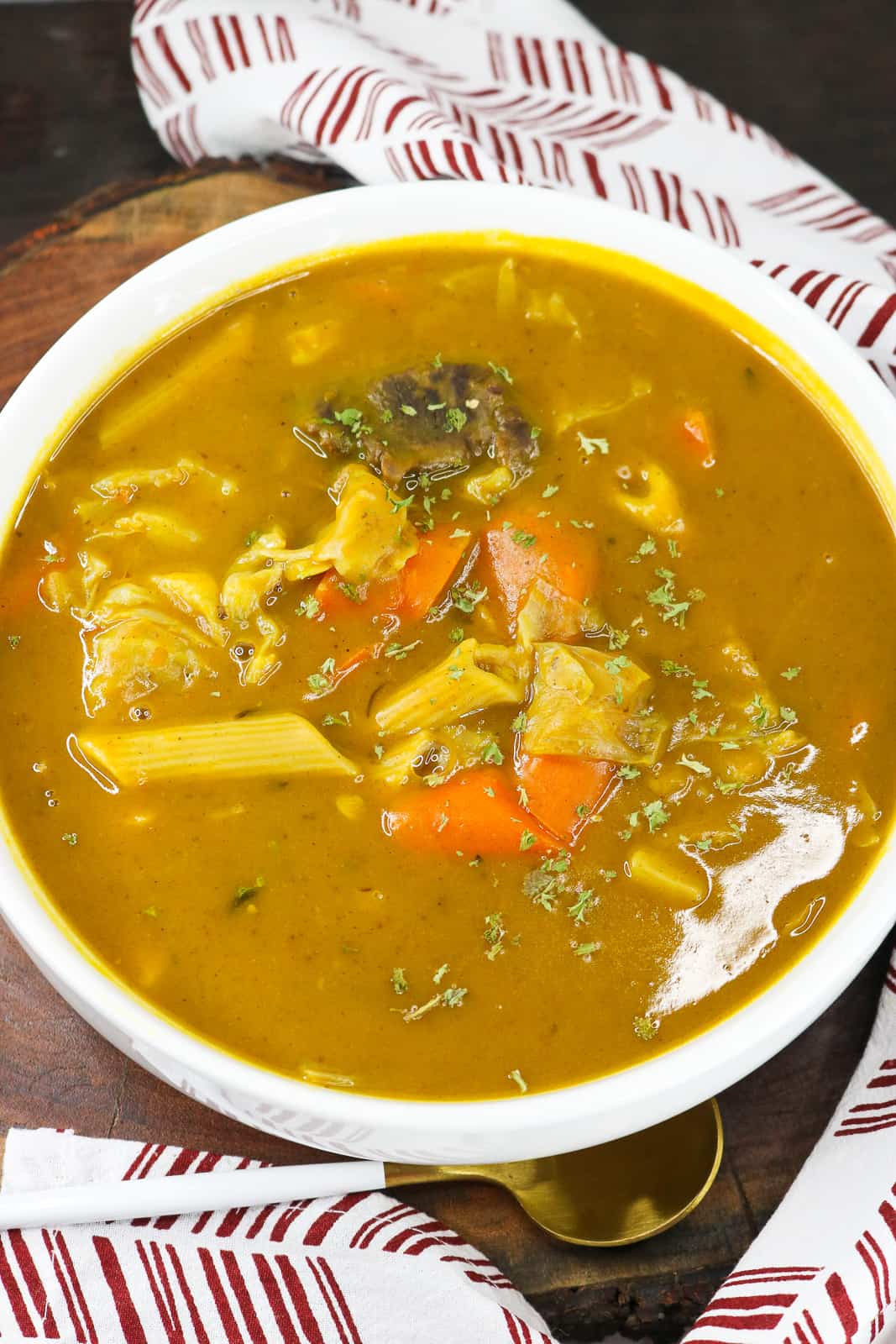 soup in white bowl on wooden cutting board