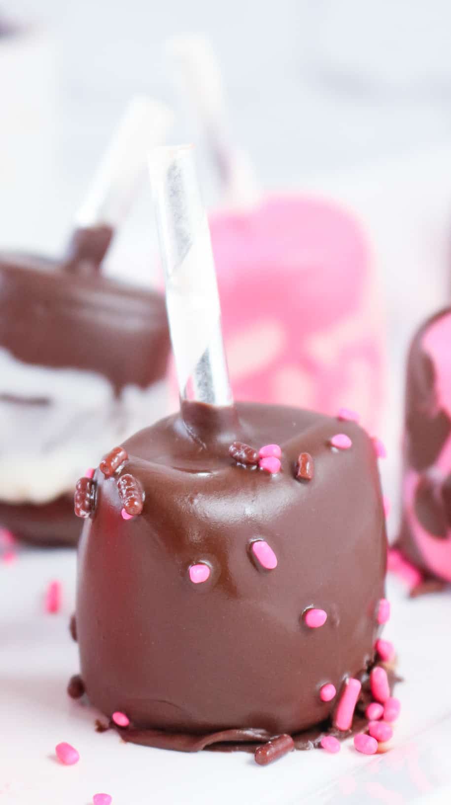 marshmallows covered in chocolate on white plate