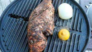 fish, onion, and lemon on grill