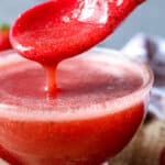 fresh syrup dripping from red spoon