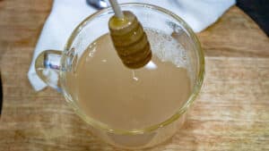 tea with honey in clear glass