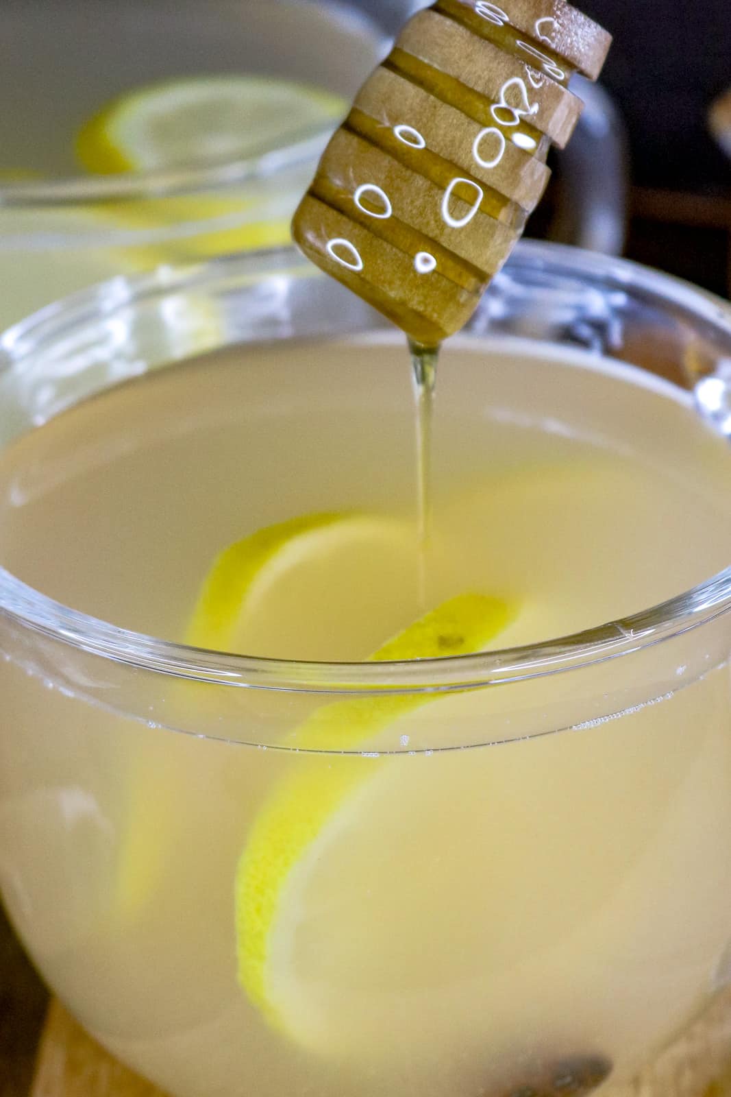 Detox tea in clear glass with honey dripping