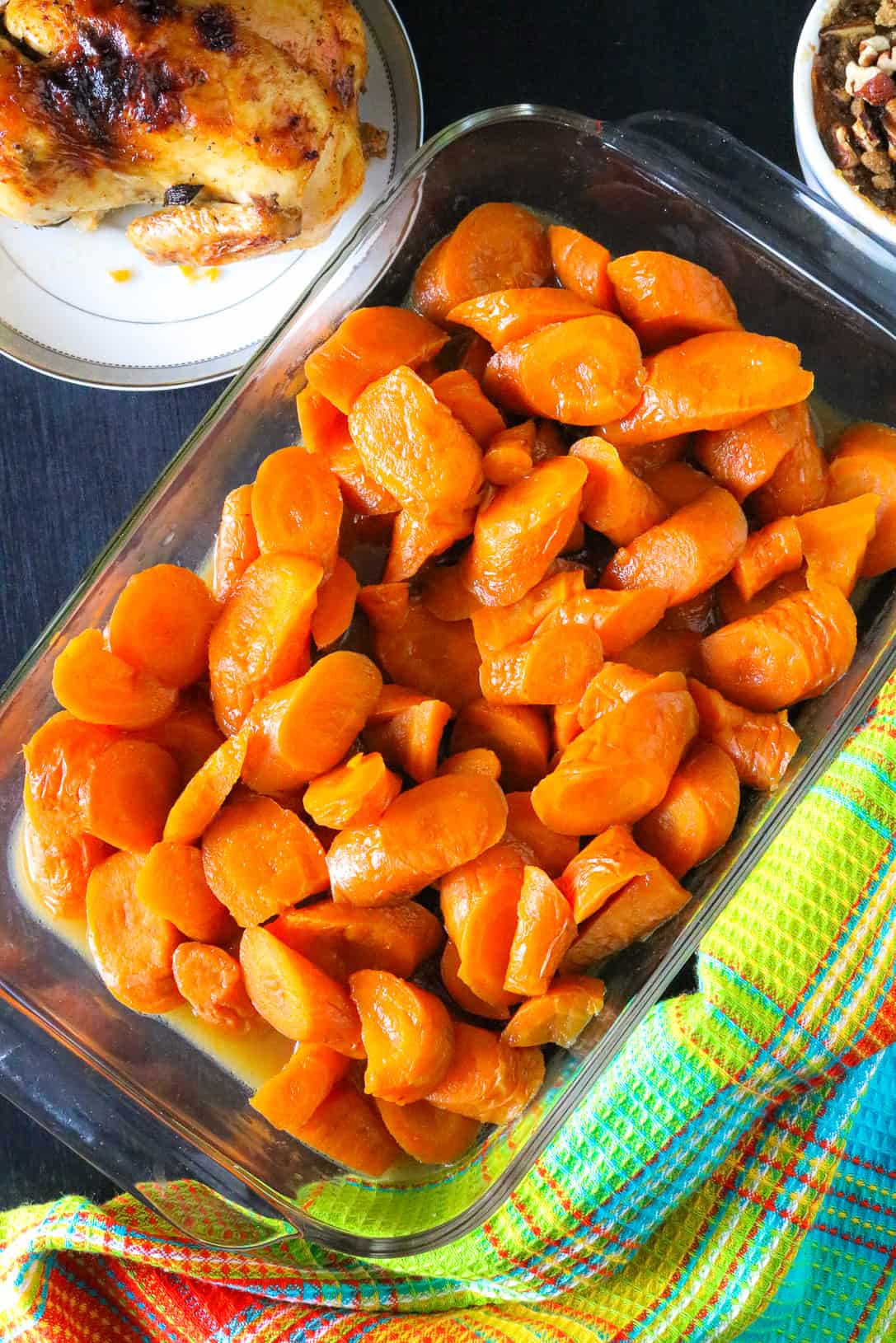 cooked carrots in glass try over dark board