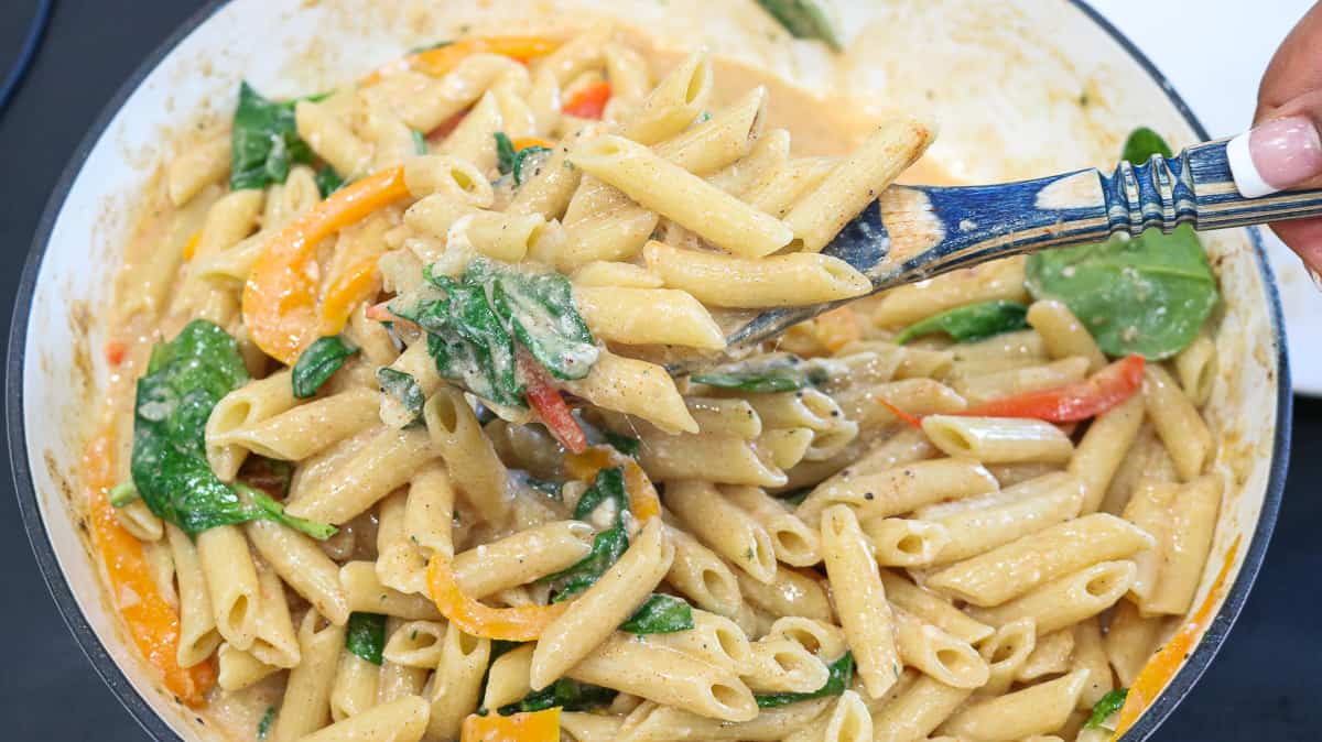 Mixing pasta with wooden spoon