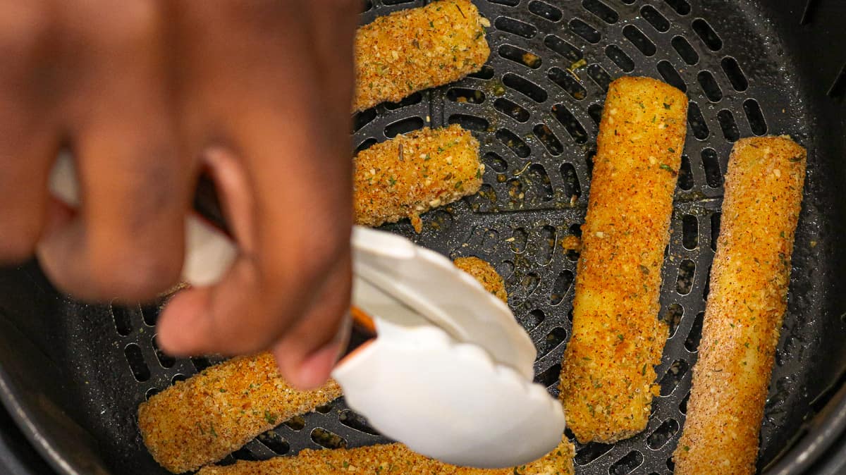 cheese sticks in basket with tong