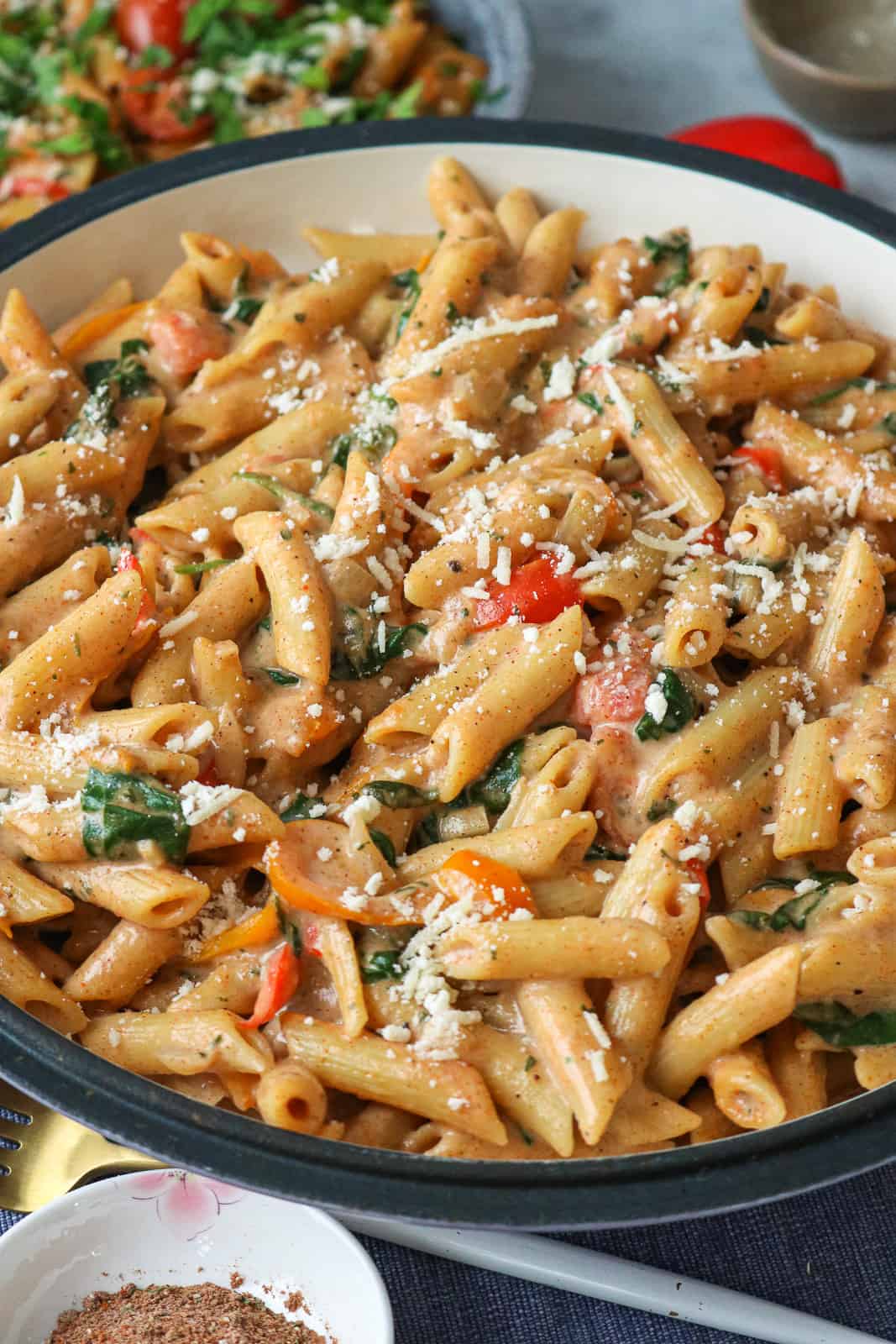 Pasta topped with cheese in large bowl