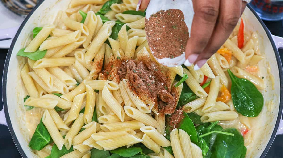 add the jerk seasoning, spinach, and pasta to sauce