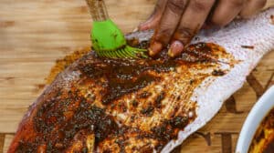 applying seasoning to fish