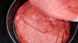 cake batter being added to pan