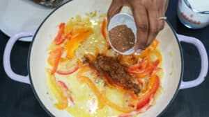 jerk seasoning being added to peppers
