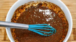 seasoning in white bowl with whisk