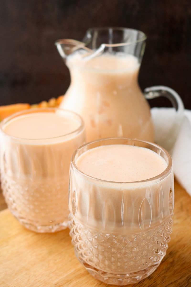 cantaloupe smoothie in glasses and pitcher