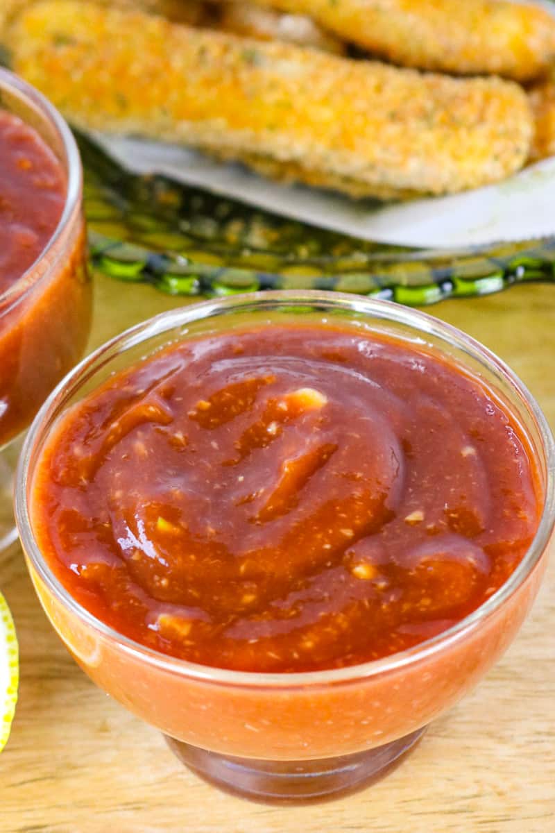 horseradish cocktail sauce in glass jar on cutting board