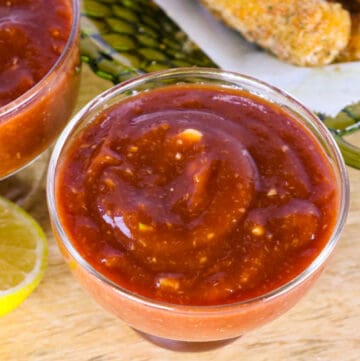 horseradish cocktail sauce in glass jar on cutting board