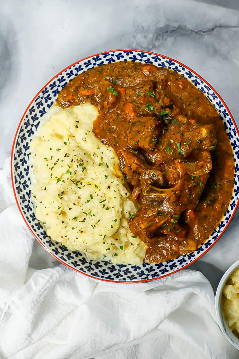 Stew with turnips mash in bowl