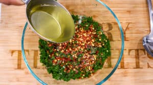 Oil being added to herbs and peppers