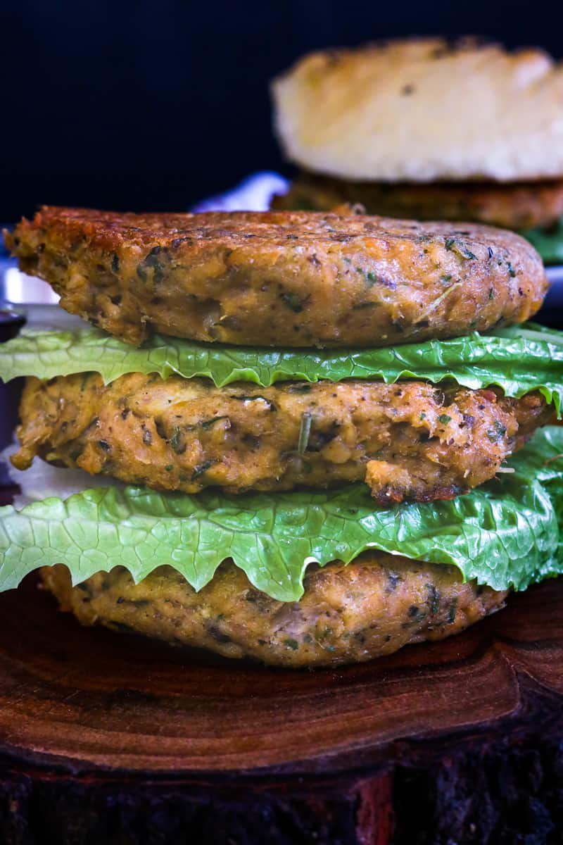 burgers stacked on top of each other with lettuce in between