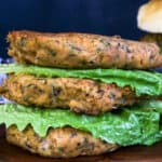 burgers stacked on top of each other with lettuce in between