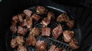 Steak bites in air fryer basket