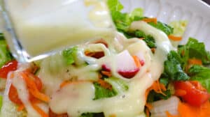 dressing pouring over salad