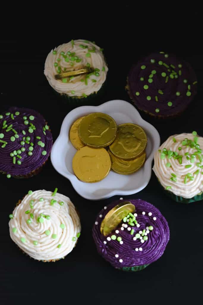 Irish cream cupcakes on black board with coins in the middle