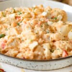 creamy potato salad in brown spotted bowl