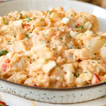 creamy potato salad in brown spotted bowl