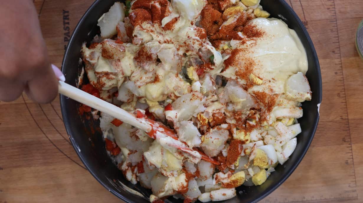 Potato and eggs with seasoning in bowl