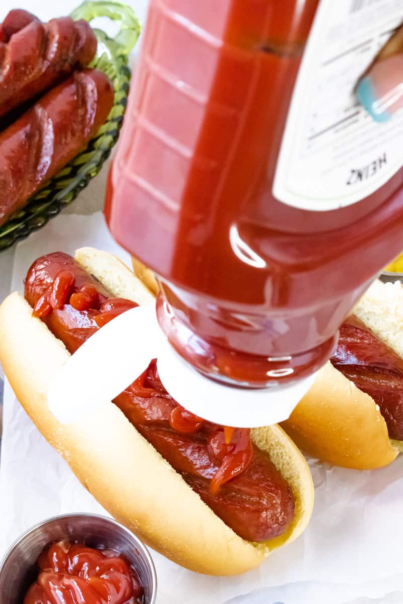 ketchup pouring over beef franks