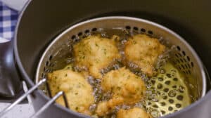 fritters in hot oil deep frying pan