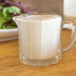 upclose view of homemade caesar dressing dressing in glass dish