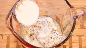 dropping parmesan cheese in measuring cup