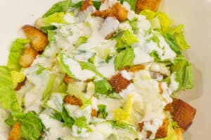 caesar salad dressed in caesar dressing
