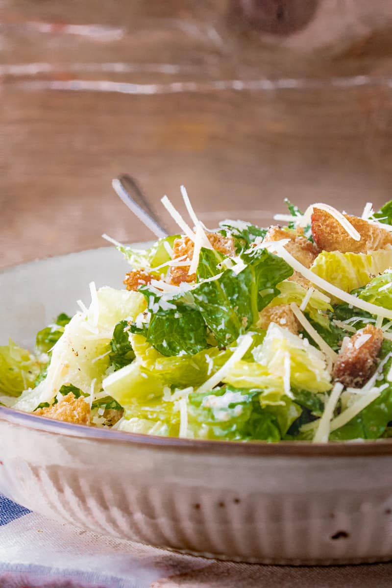 Caesar salad recipe with fork in the bowl