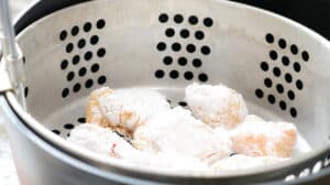 chicken pieces in frying basket
