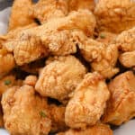 fried chicken in bowl lined with parchment paper