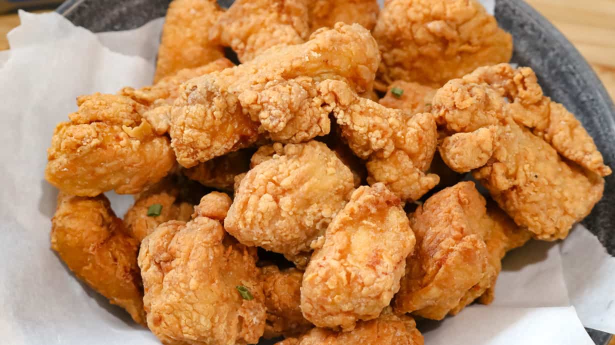 fried chicken in bowl lined with parchment paper