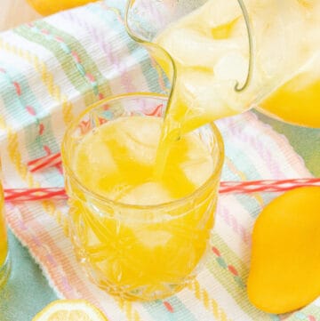 Mango lemonade being poured in glass