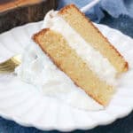 Haitian Cake with cream cheese icing on white plate with fork