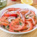 tomatoes and onions in white plate