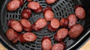 partially cooked air fryer sausage in basket