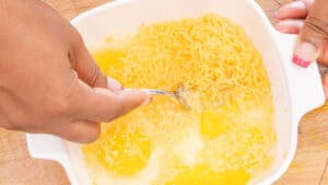 whisking eggs in white bowl