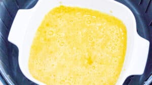 whisked eggs in white bowl