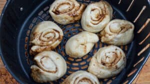 cinnamon rolls placed in the air fryer basket