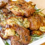potatoes on board with rosemary in white tray