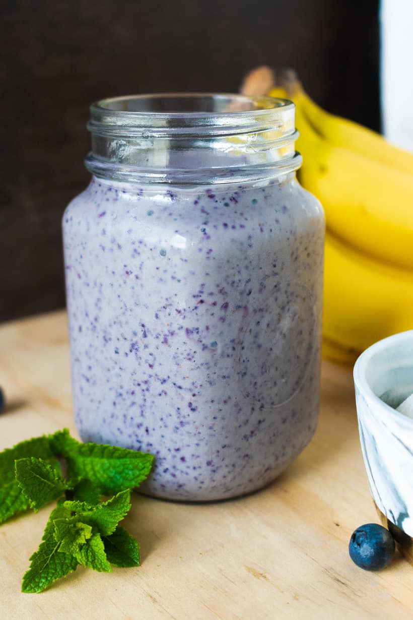 shake, mint and blueberries on wooden board