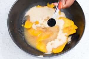 adding vanilla extract to mango mixture